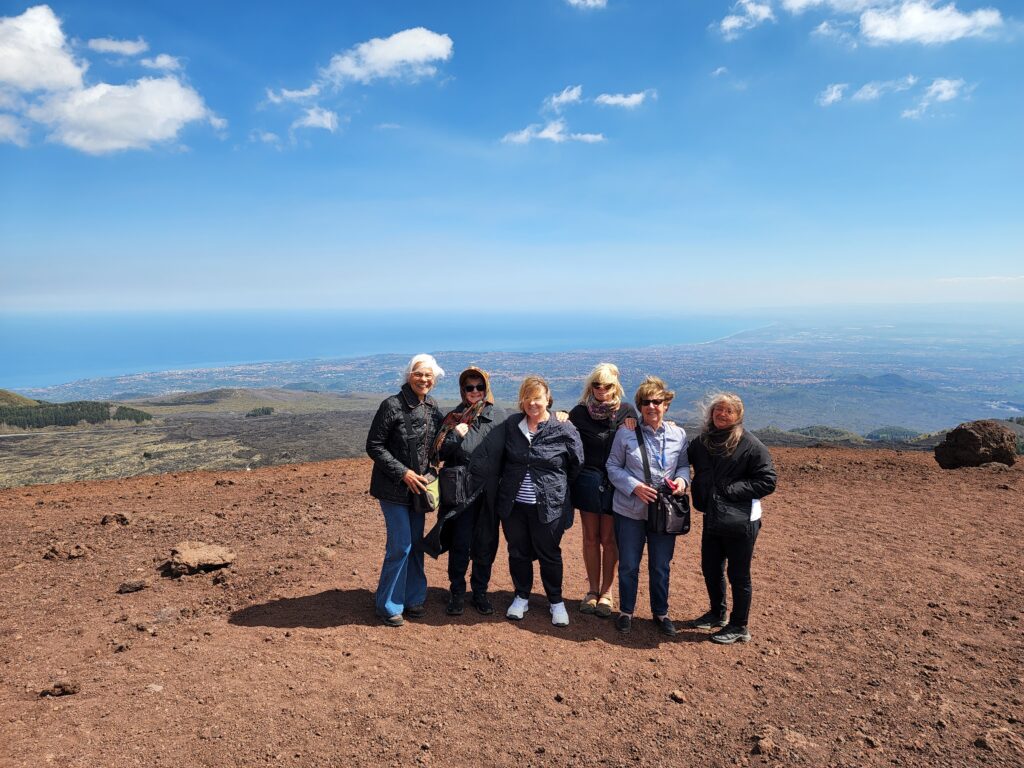 Travellers on our Colours of Sicily small group tour enjoying the views atop Mt Etna. 